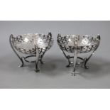 A pair of Edwardian pierced silver bon bon dishes, on raised tripod supports, E.S. Barnsley & Co,