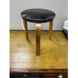 An Alvar Aalto three-legged stool, seat diameter 35cm, height 44cm