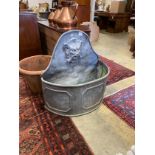 An early 18th century style 'D' shaped lead cistern with mask spout, width 80cm, depth 36cm,