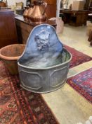 An early 18th century style 'D' shaped lead cistern with mask spout, width 80cm, depth 36cm,