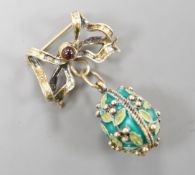 A mid 20th century Soviet gilt 925 and enamelled egg pendant, 21mm, on a gilt white metal ribbon bow