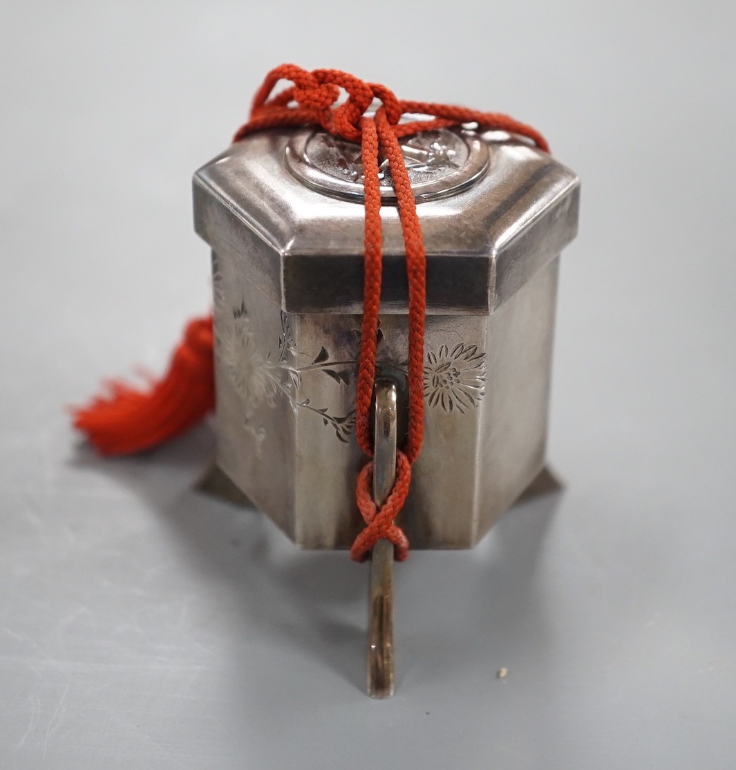 An early 20th century Japanese white metal hexagonal box and cover, signed to the base, height 53mm,