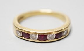 A modern 18ct gold and channel set four stone diamond and three stone ruby set half hoop ring,