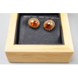 A modern pair of 9ct gold and fire opal set oval earrings, 11mm, gross weight 1.8 grams.