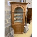 A George III style pitch pine standing corner cabinet, width 96cm, depth 34cm, height 199cm