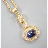 A modern yellow metal, cabochon sapphire and diamond set cluster pendant, overall 30mm, gross 4