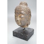 A Chinese stone Buddha’s head on stand 19cm total height