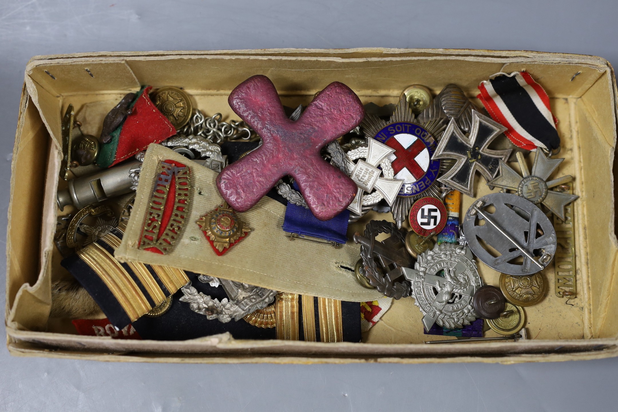 A mixed collection of German Third Reich and other military badges and buttons