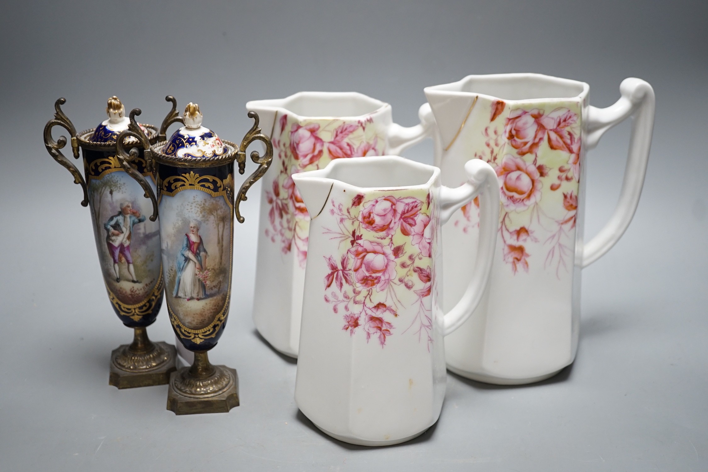 A pair of 19th century French porcelain and gilt metal vases and graded set of three continental