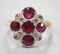 A 1920's 18ct and plat and five stone ruby set quatrefoil shaped ring, with diamond chip spacers,
