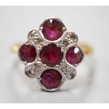 A 1920's 18ct and plat and five stone ruby set quatrefoil shaped ring, with diamond chip spacers,