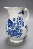 A Caughley baluster mask jug printed in underglaze blue with the 'parrot pecking fruit', 18.5cms