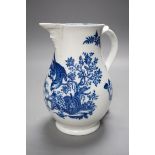 A Caughley baluster mask jug printed in underglaze blue with the 'parrot pecking fruit', 18.5cms