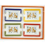 A boxed set of four Hermes porcelain ashtrays decorated with leopards, 8 cm.