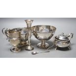 A late Victorian silver helmet shaped cream jug, a silver sugar bowl, a silver mustard pot, a silver