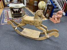 A carved pine rocking horse, height 93cm.