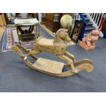 A carved pine rocking horse, height 93cm.