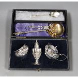 A cased George V silver three piece condiment set, lacking spoons, a 1930's Arts & Crafts sile r