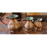 A set of three Victorian copper measures, largest height 29cm
