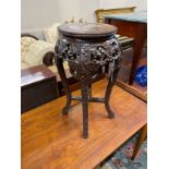 A Chinese circular carved hardwood marble topped jardiniere stand, height 62cm