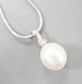 A modern 18ct white, gold, cultured pearl and diamond set pendant, 20mm, gross 2.7 grams, on a