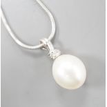 A modern 18ct white, gold, cultured pearl and diamond set pendant, 20mm, gross 2.7 grams, on a