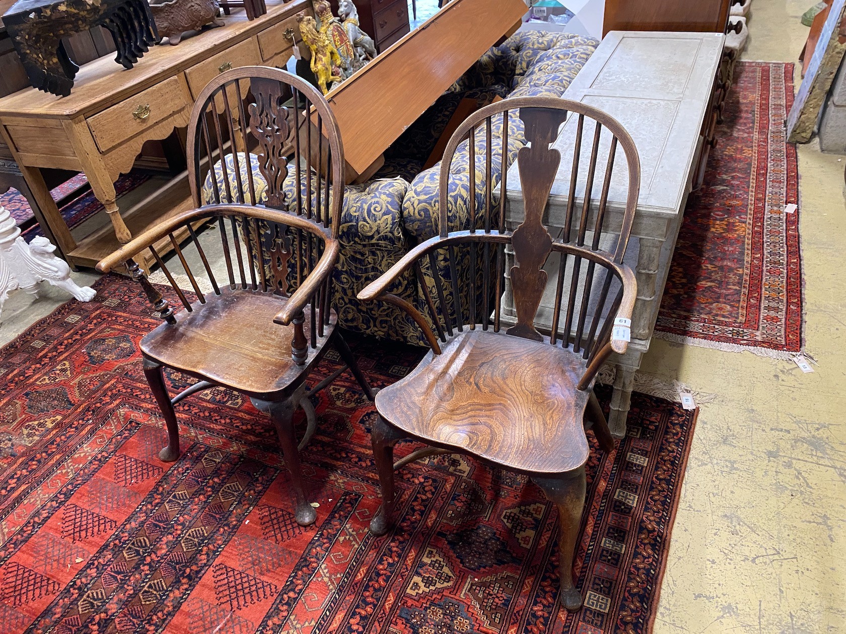 Two 19th century elm and ash Windsor elbow chairs, on front cabriole legs and crinoline
