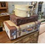 A leather and canvas covered suitcase, a small brown leather suitcase and hatbox, largest width