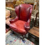 A George III style mahogany red leather upholstered wing armchair, width 91cm, depth 60cm, height