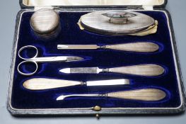 A cased George V silver mounted seven piece manicure set, Birmingham, 1923.