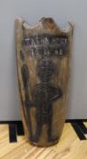 A tribal carved wood shield, inscribed Tasha Andy 16 4 08, 77cm