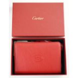 A Cartier red leather notebook, boxed, with bag, papers and certificate