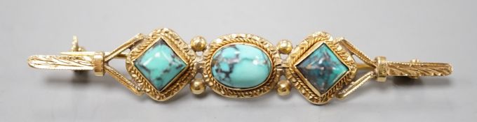 A 750 yellow metal and three stone shaped turquoise set bar brooch, 57mm, gross weight 6.6 grams.
