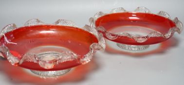 A pair of early 20th century ‘fancy’ glass dishes with inset coins to base, 29cm diameter