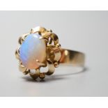 A 14k yellow metal and white opal set oval dress ring, size O, gross weight 3.9 grams.