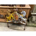 A Victorian painted cast iron Royal Coat of Arms, on later wrought iron stand, width 69cm, height