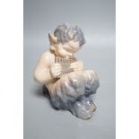 A Royal Copenhagen porcelain model of a seated faun, number 1736, 13cm tall