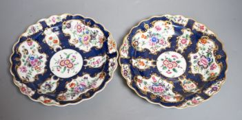 A fine pair of Worcester blue scale plates gilded with mirror like panels, painted with flowers,