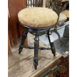 A Victorian ebonised adjustable revolving piano stool