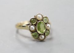 An early 20th century yellow metal, peridot and split pearl cluster set dress ring, size N, gross