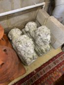 A pair of reconstituted stone recumbent lion garden ornaments, length 70cm, height 50cm