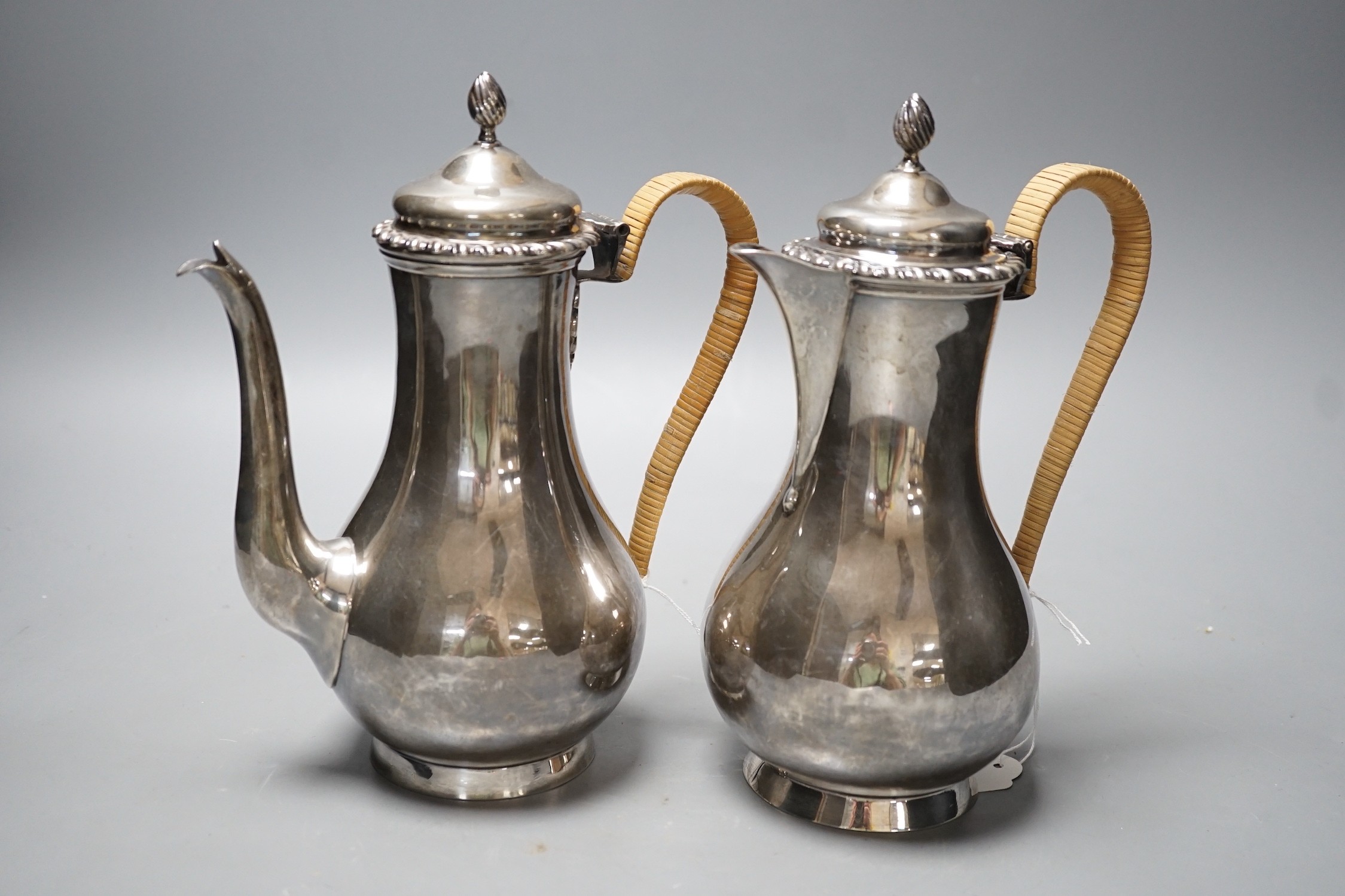 A matched early 20th century silver cafe au lait pair, London, 1900 & 1903, one by Edward Charles