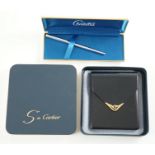 An S de Cartier navy blue leather cigarette case with blue cabochon set clasp, 11 cm., boxed and a