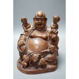 A Chinese carved wood group of Budai, 24cm