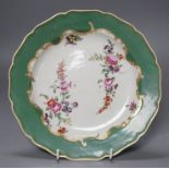 A Worcester plate with apple green border, painted wih two large sprays of flowers and three