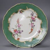 A Worcester plate with apple green border, painted wih two large sprays of flowers and three