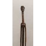 A West African tribal carved hardwood tall standing figure. 140cm high