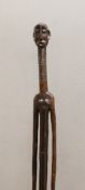 A West African tribal carved hardwood tall standing figure. 140cm high