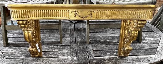 An 18th century style carved giltwood and composition console table (lacks marble top), width