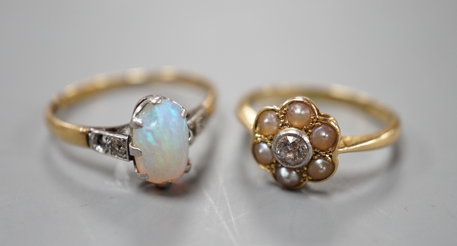 An 18ct and Plat, split pearl and diamond cluster set ring, size F/G and a similar white opal set